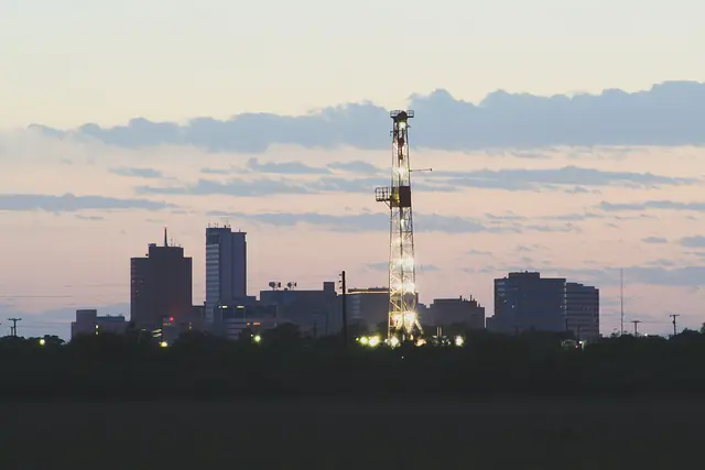 An oilfield drilling rig and the downtown Midland, Texas skyline